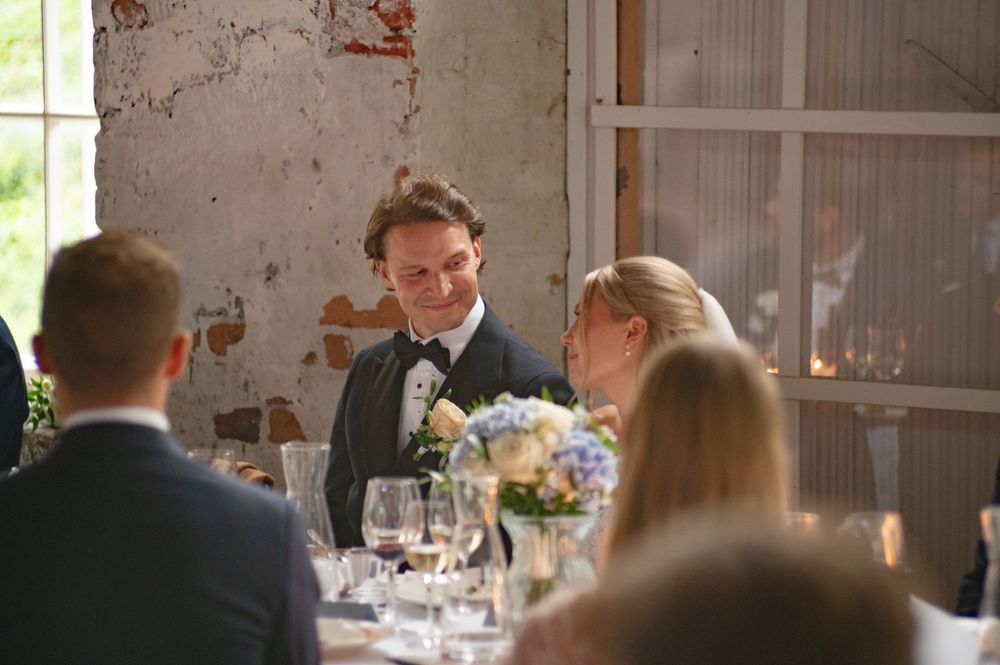 Rustic wedding venue interior with exposed brick walls and natural lighting.