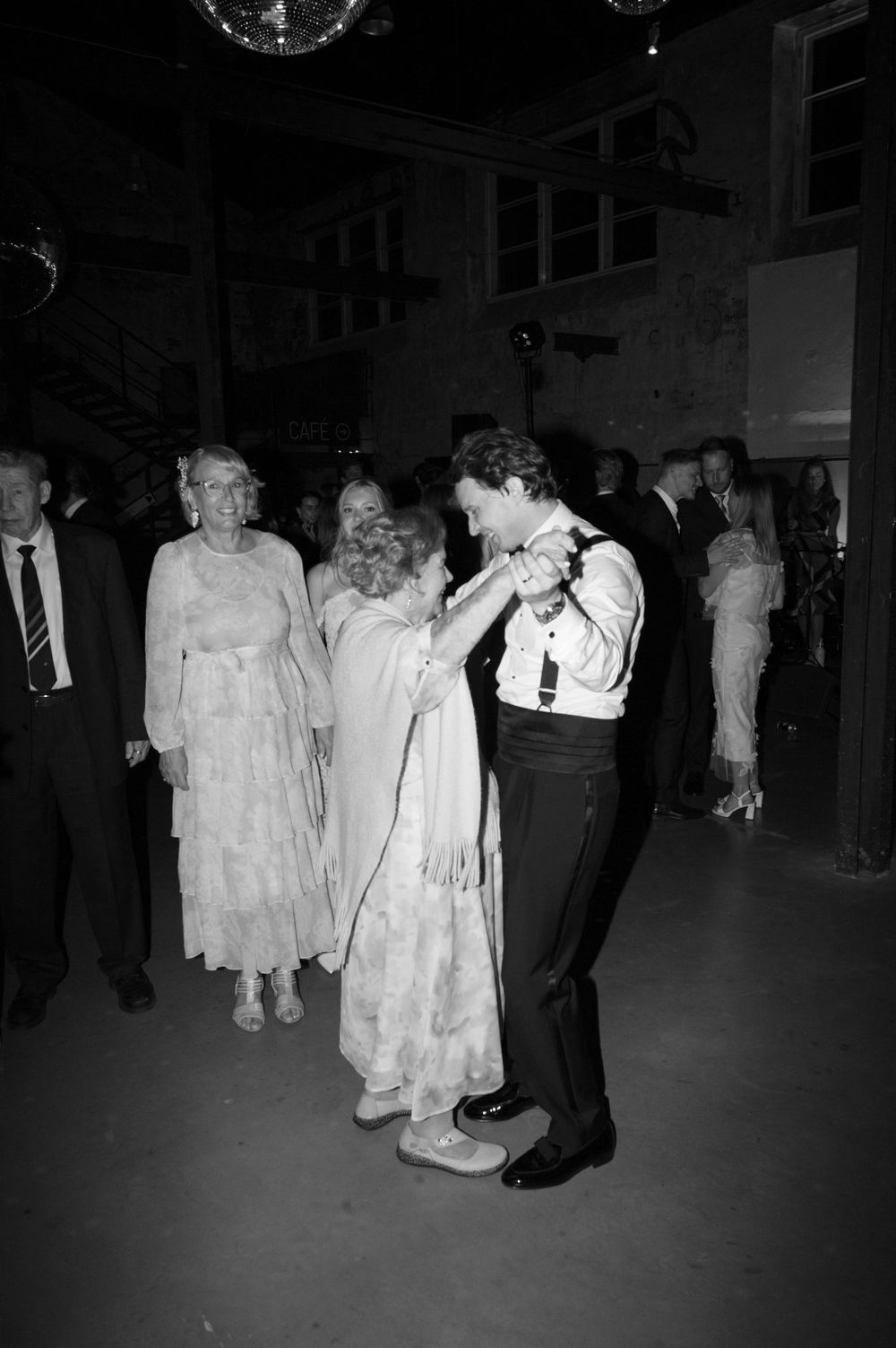 Black and white photos of people dancing at a formal event with disco ball overhead.