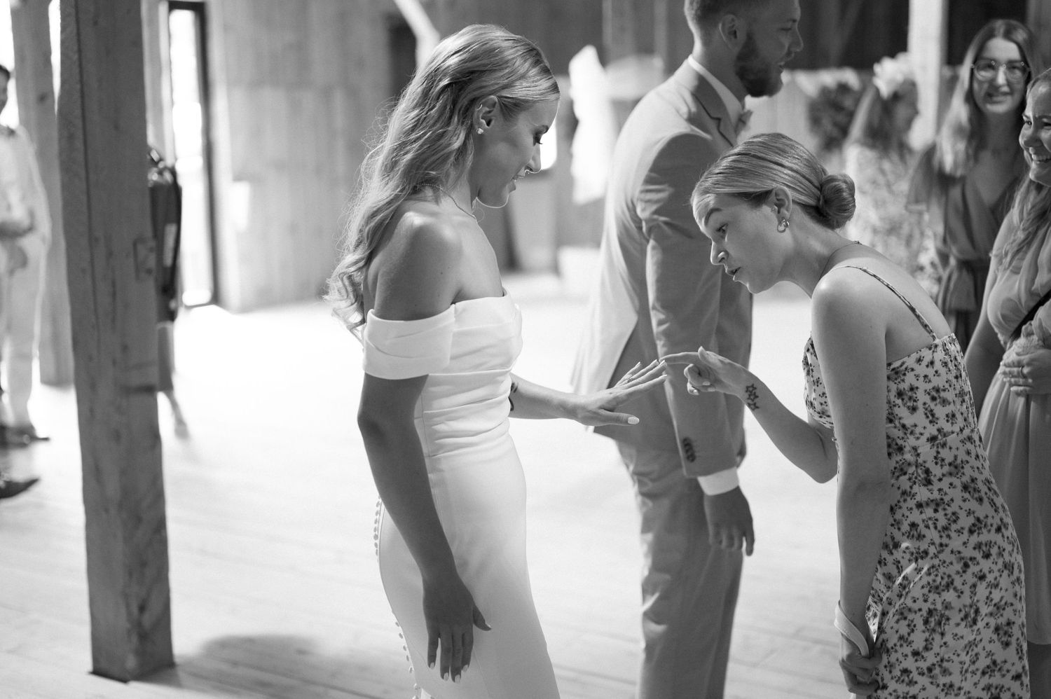 Guests dance and celebrate at an indoor wedding reception.