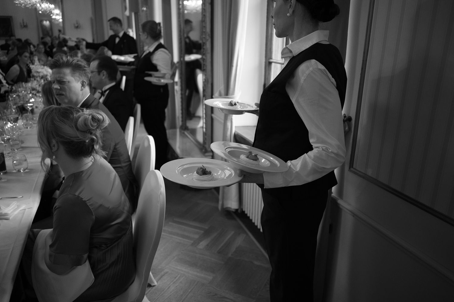 Black and white photographs showing people dancing at what appears to be a wedding or formal celebration.
