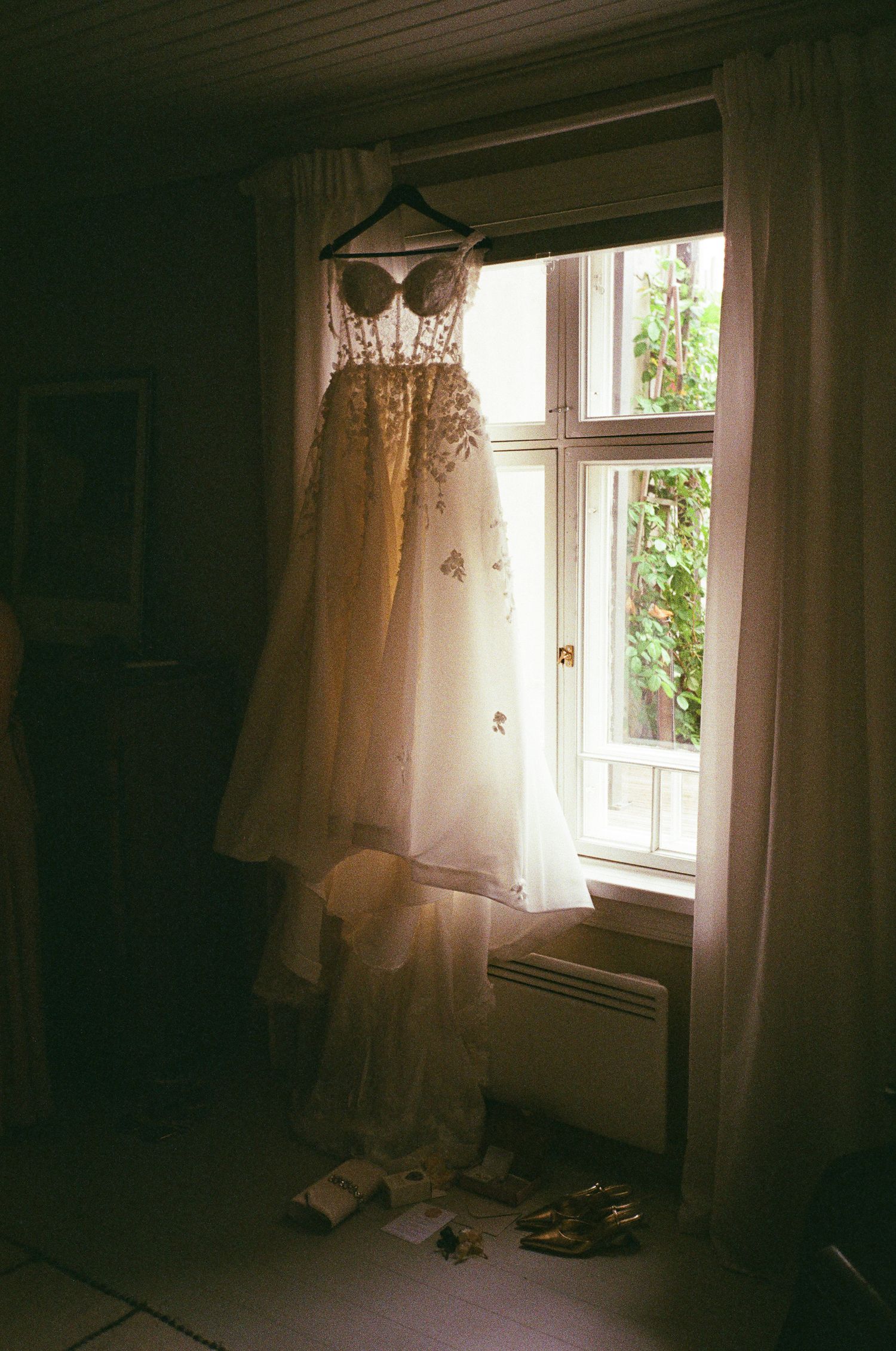 Sunlit interior room with sheer white curtains and window casting soft natural light.