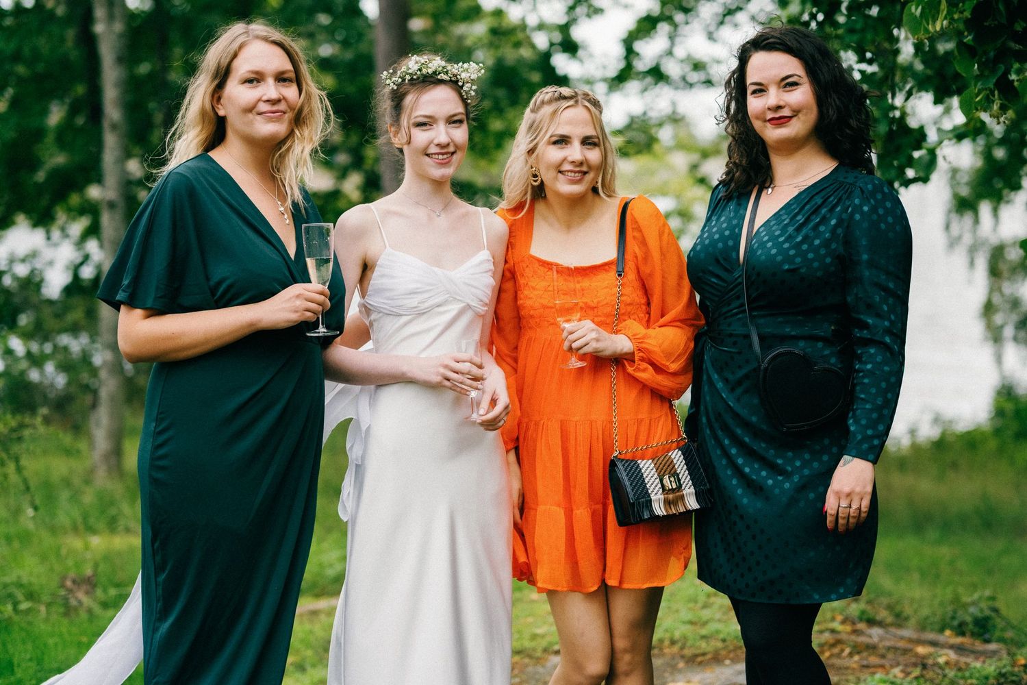 Group of party guests in colorful attire socializing at an outdoor event.