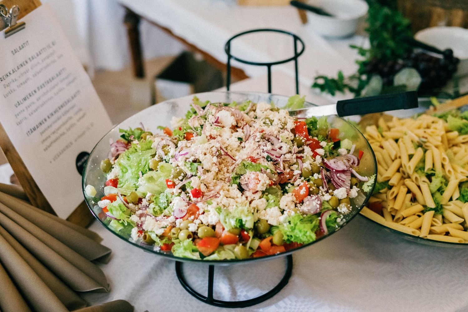 Fresh garden salad with colorful vegetables and toppings served on an elevated platter.
