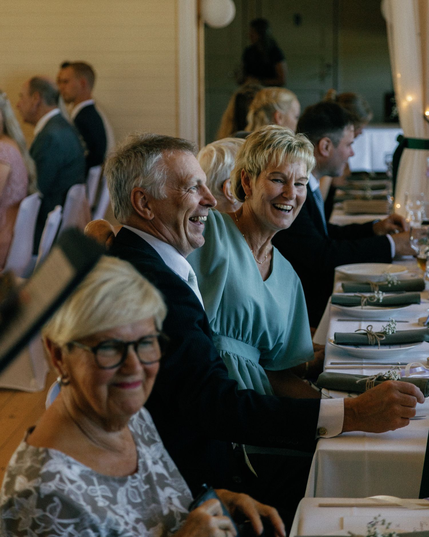 Wedding guests enjoying conversation at decorated reception tables.