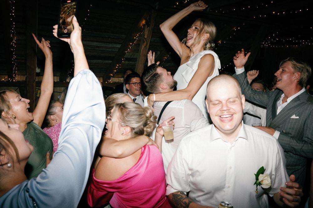 Guests enjoying themselves on the dance floor during a wedding celebration.