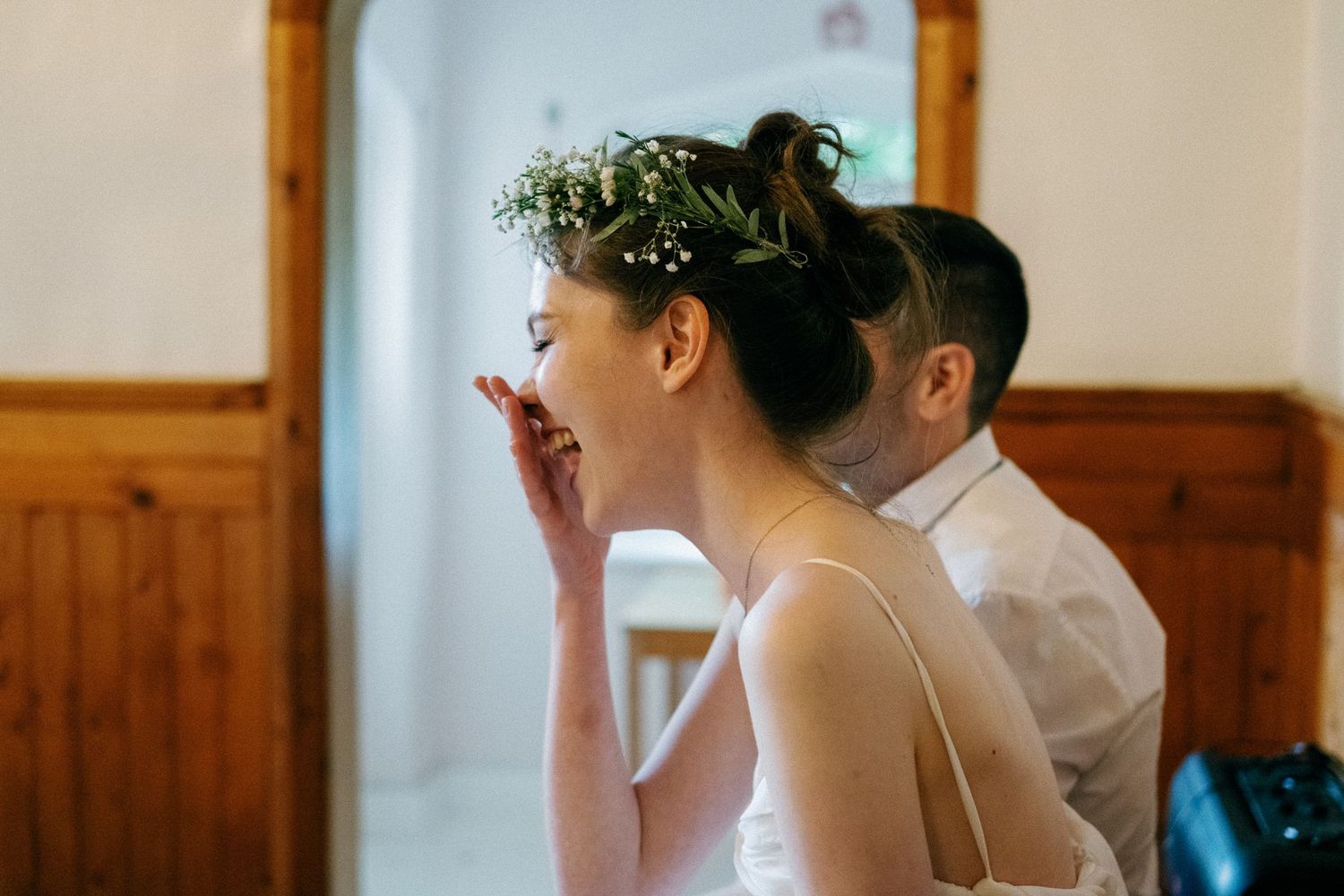 Joyful celebration moments captured during an indoor wedding reception.