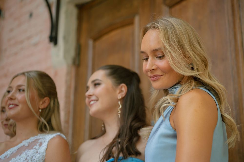 Close-up of bridesmaids sharing joyful laughter during wedding celebrations.