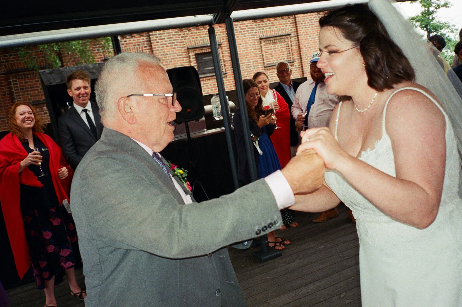 Wedding reception dance floor moments with guests celebrating.