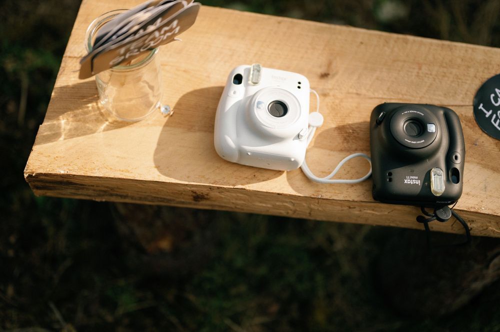 Vintage cameras displayed on wooden shelves at a rustic wedding venue.