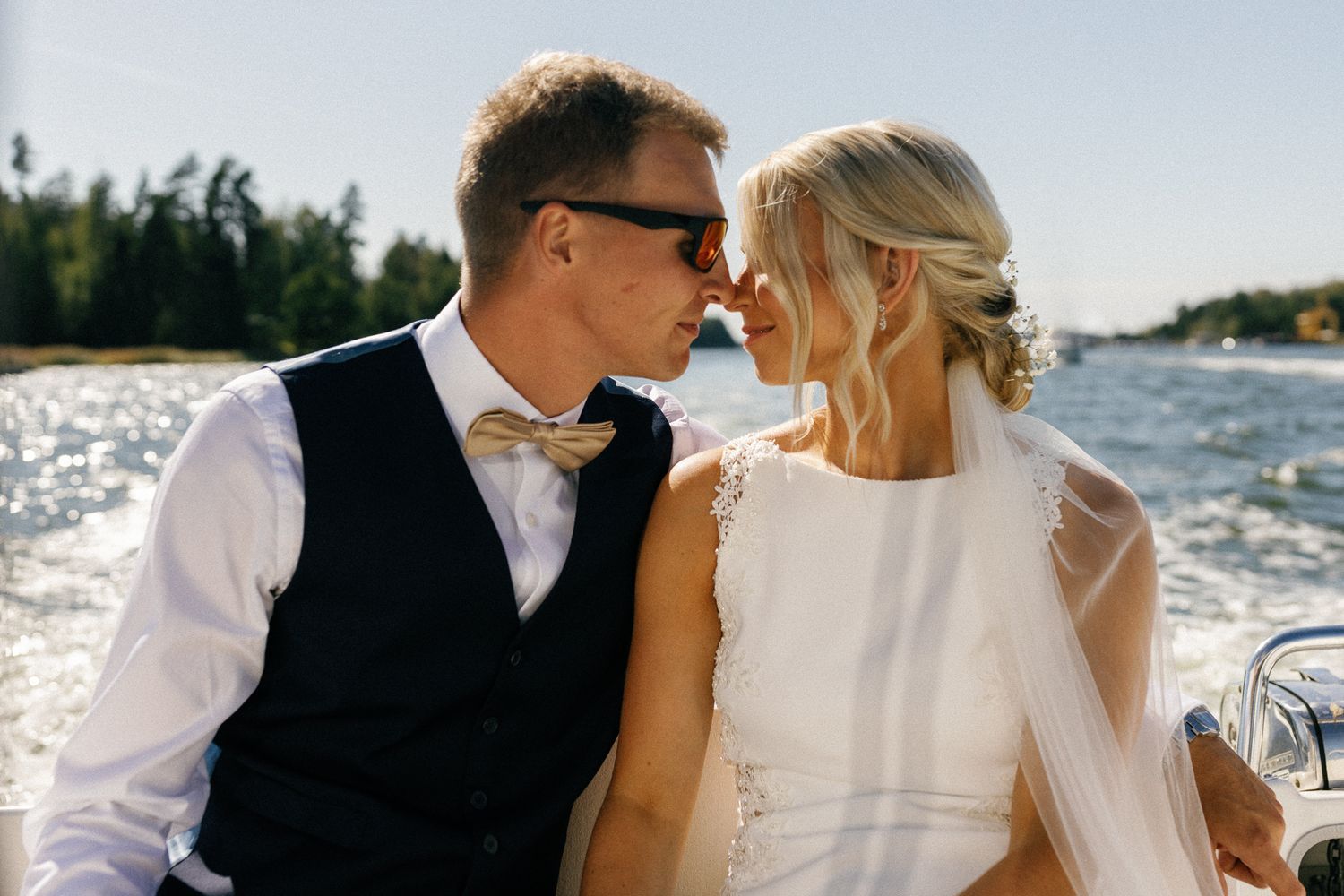 Elegant wedding couple sharing romantic moments aboard a boat.