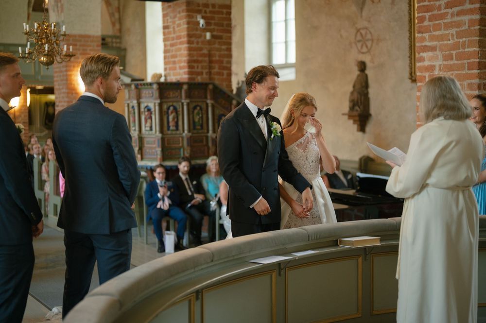Wedding guests socializing in the historic church interior after the ceremony.