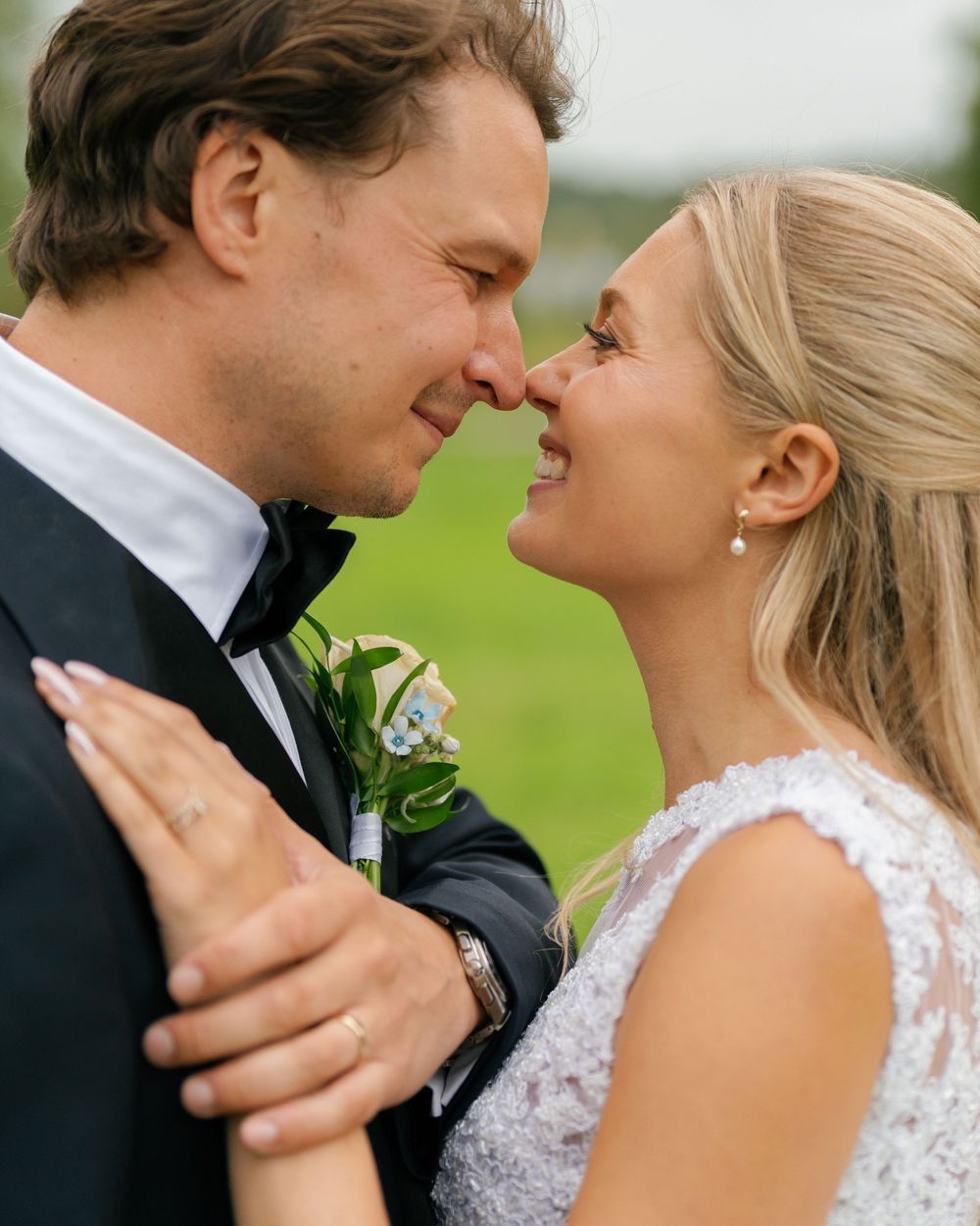 Romantic close-up of newlyweds sharing an intimate moment outdoors.