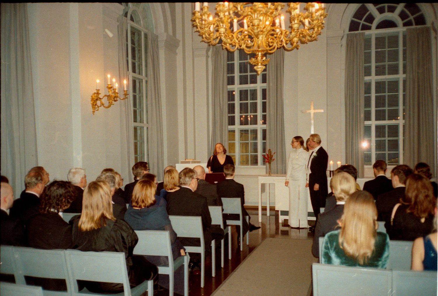A series of elegant wedding ceremony photos showing a grand ballroom with chandeliers and guests in formal attire.
