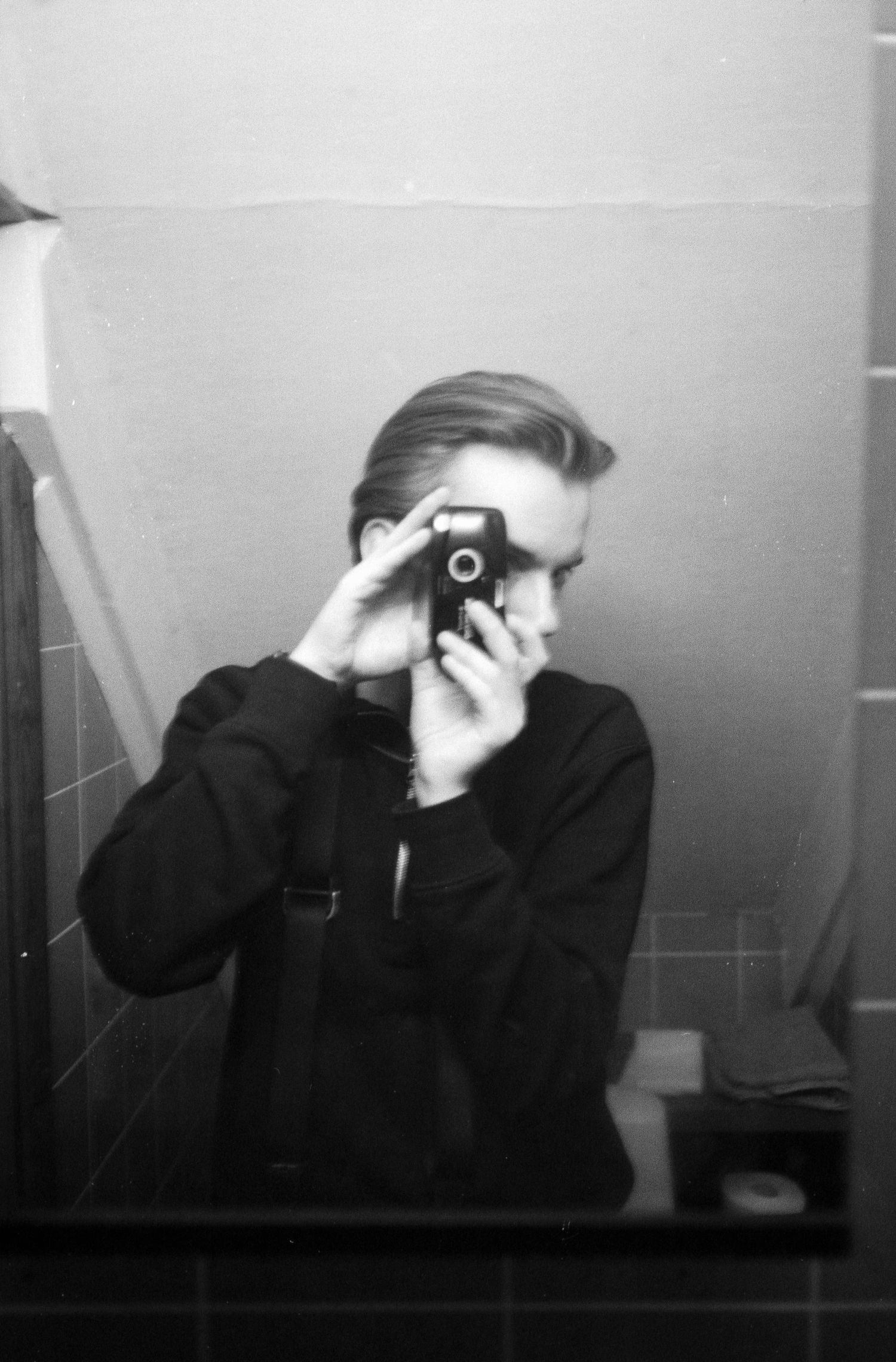 Series of artistic black and white self-portraits showing different camera angles and poses.