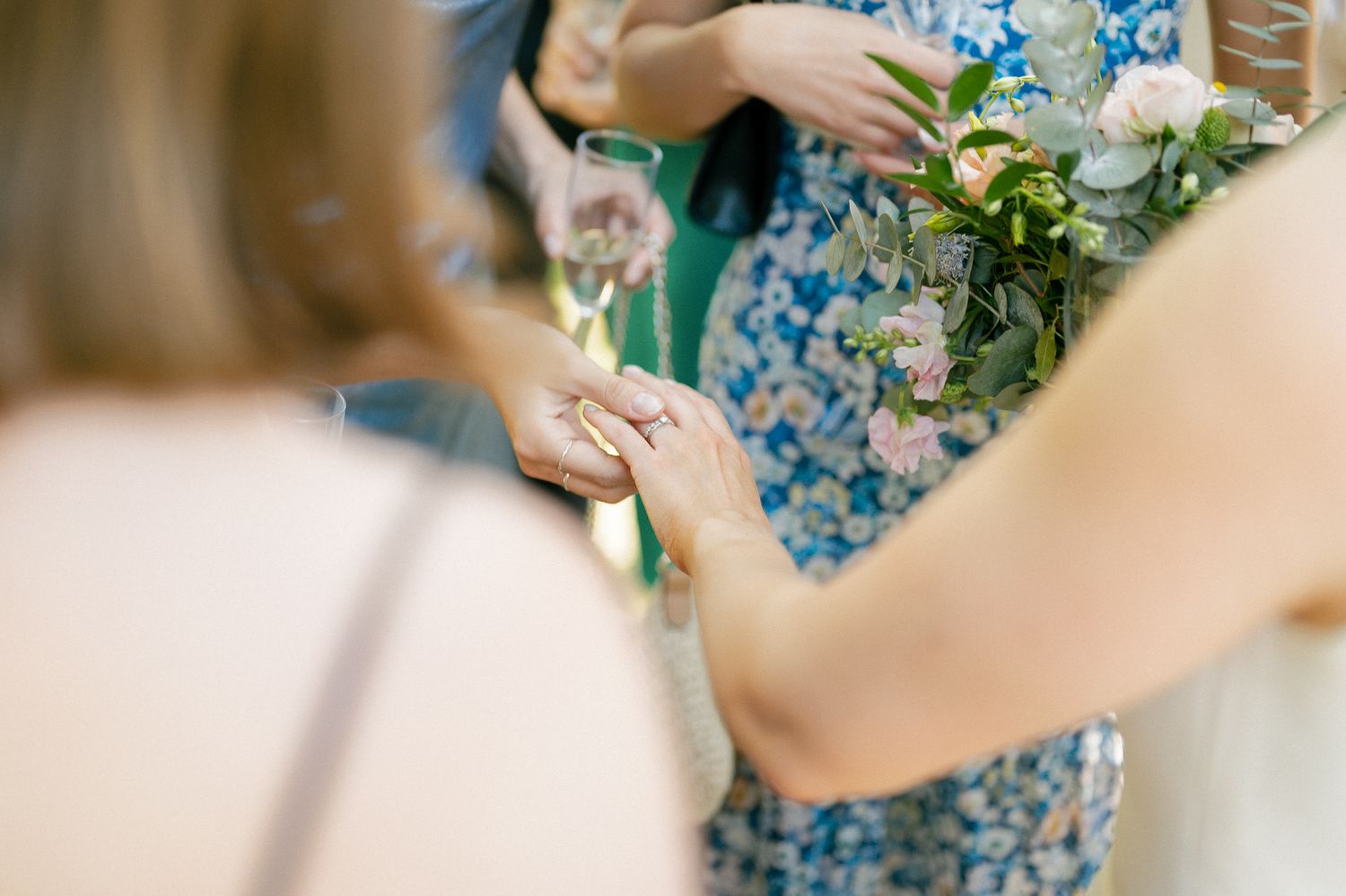 Wedding bouquet details featuring blue and white flowers with decorative elements.