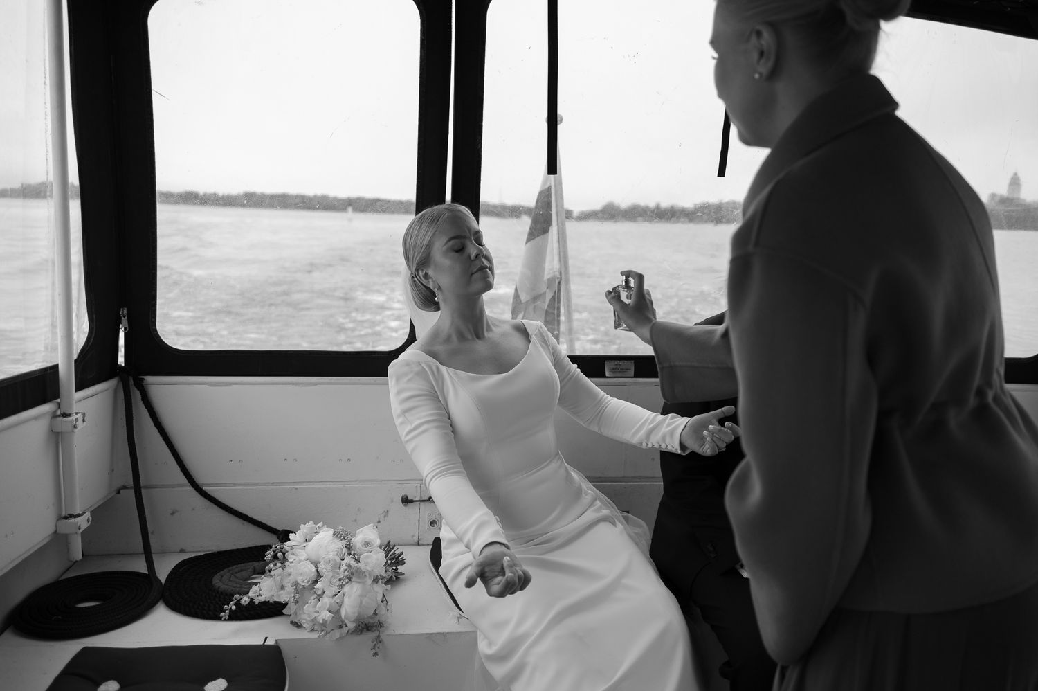 Inside a vehicle, a couple sits together in formal attire during what appears to be a special occasion.