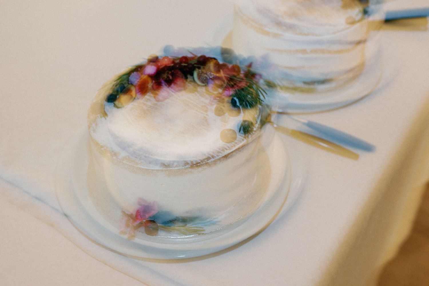 Elegant wedding cake decorated with delicate floral details and pastel colors.