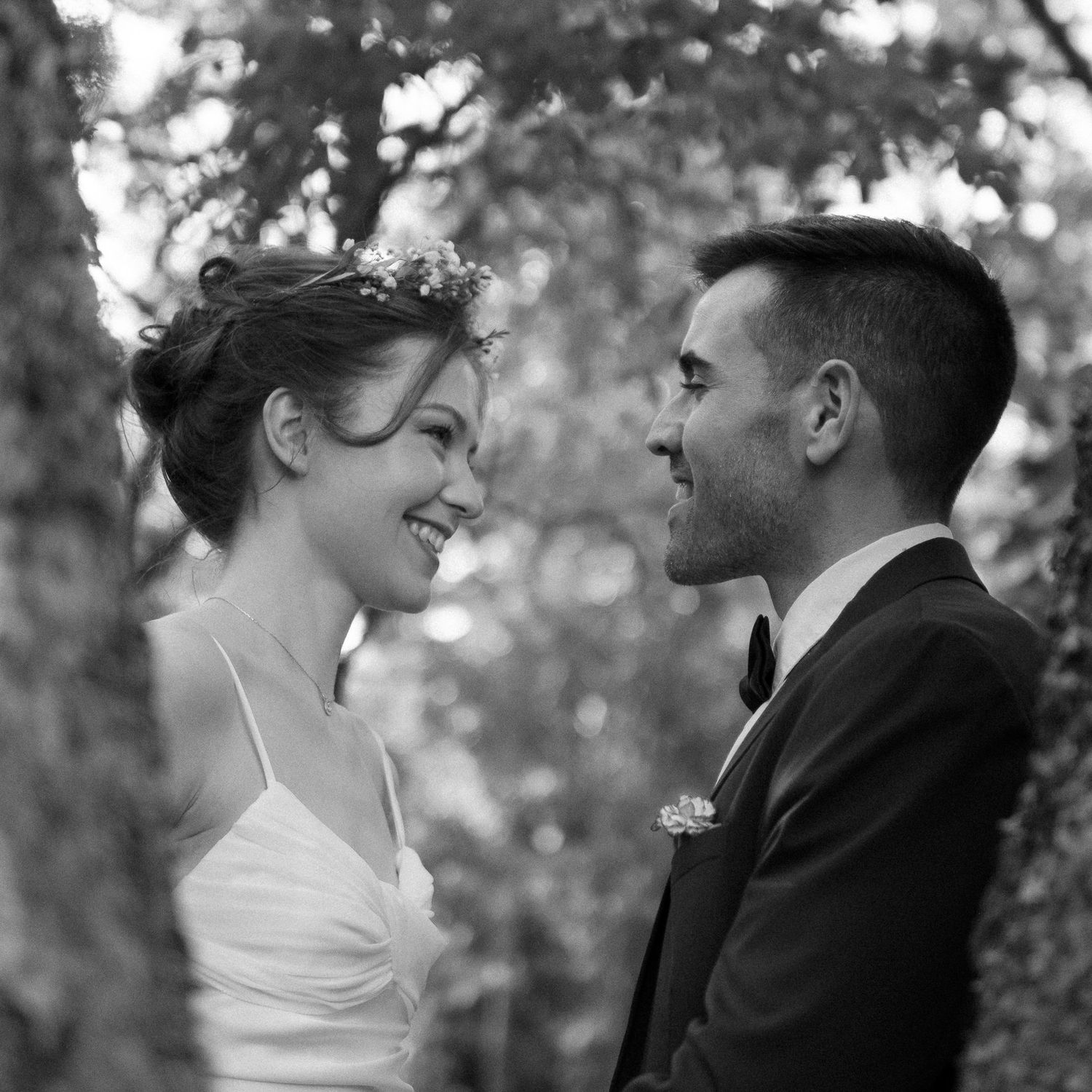 Black and white wedding portrait series capturing romantic moments between newlyweds.
