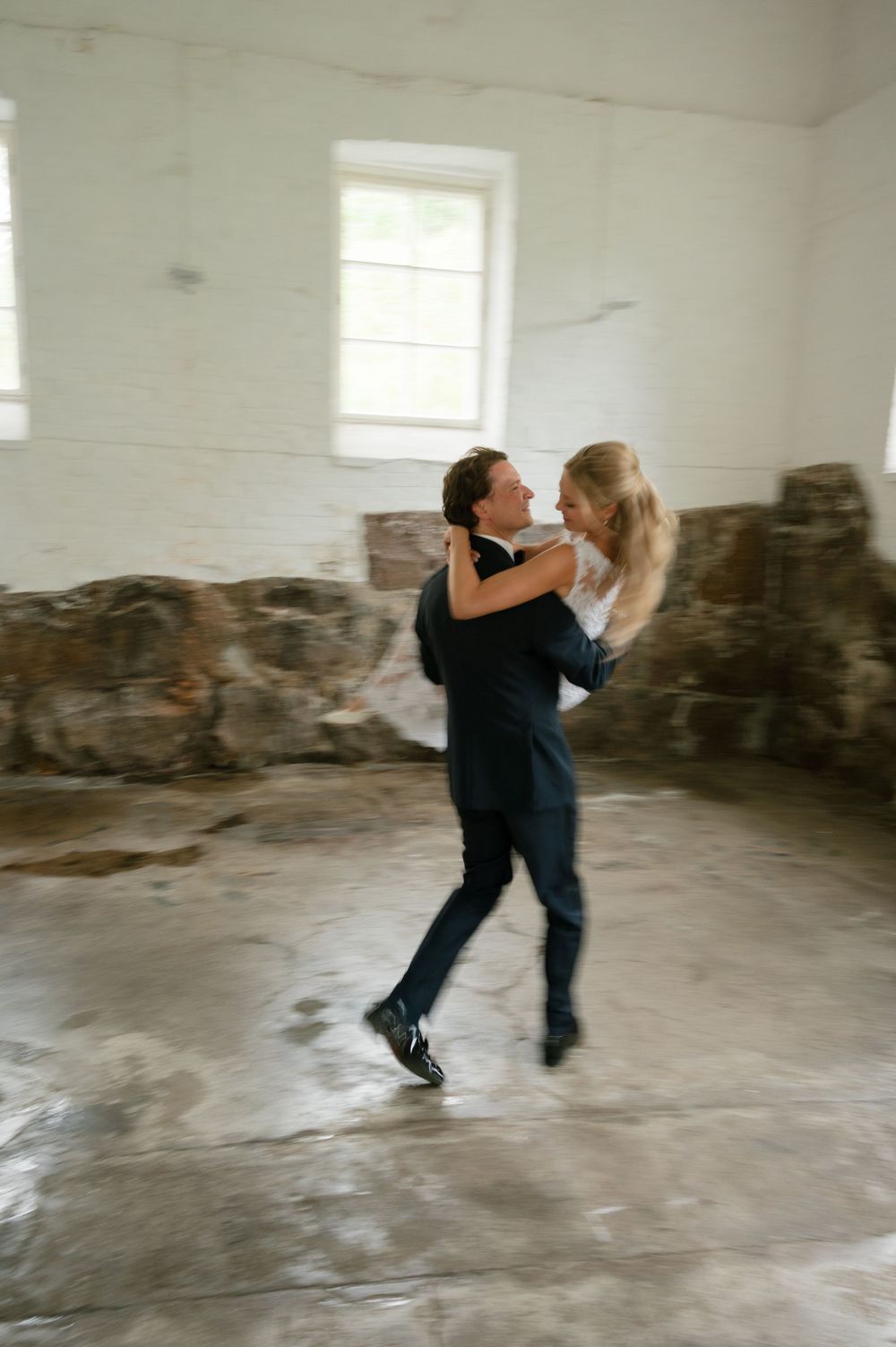 Dynamic dance movements captured in sequence within a rustic white-walled room.