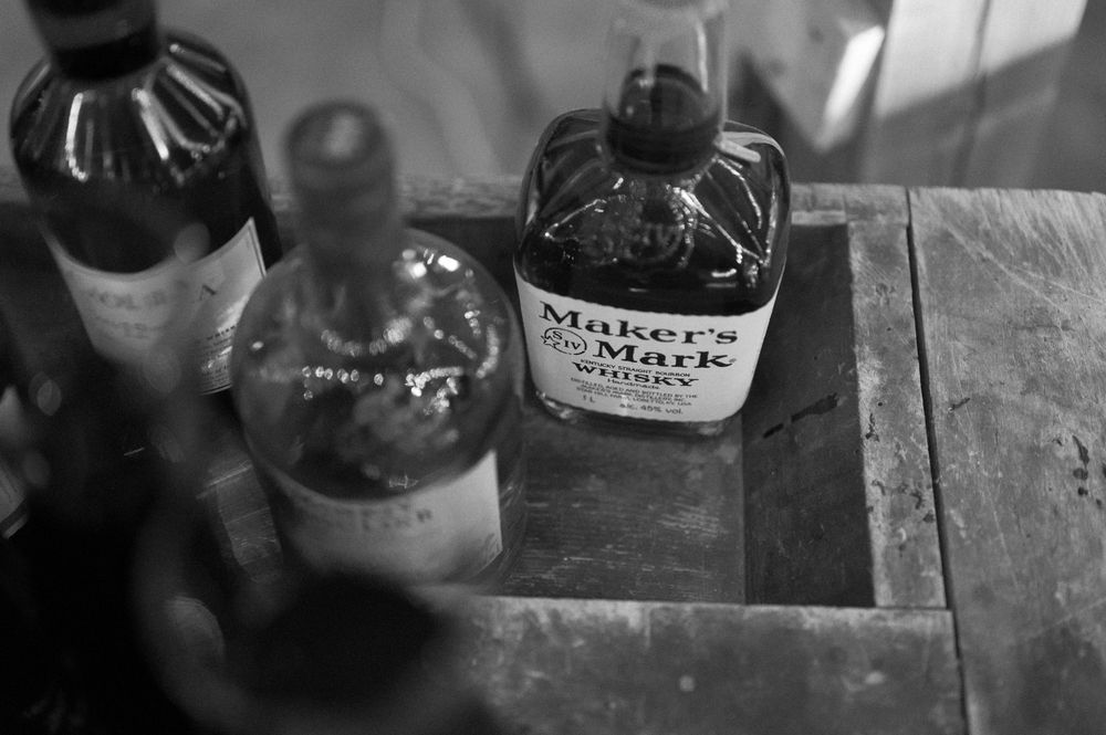 Close-up details of vintage glass bottles and decorative elements on wooden surface.