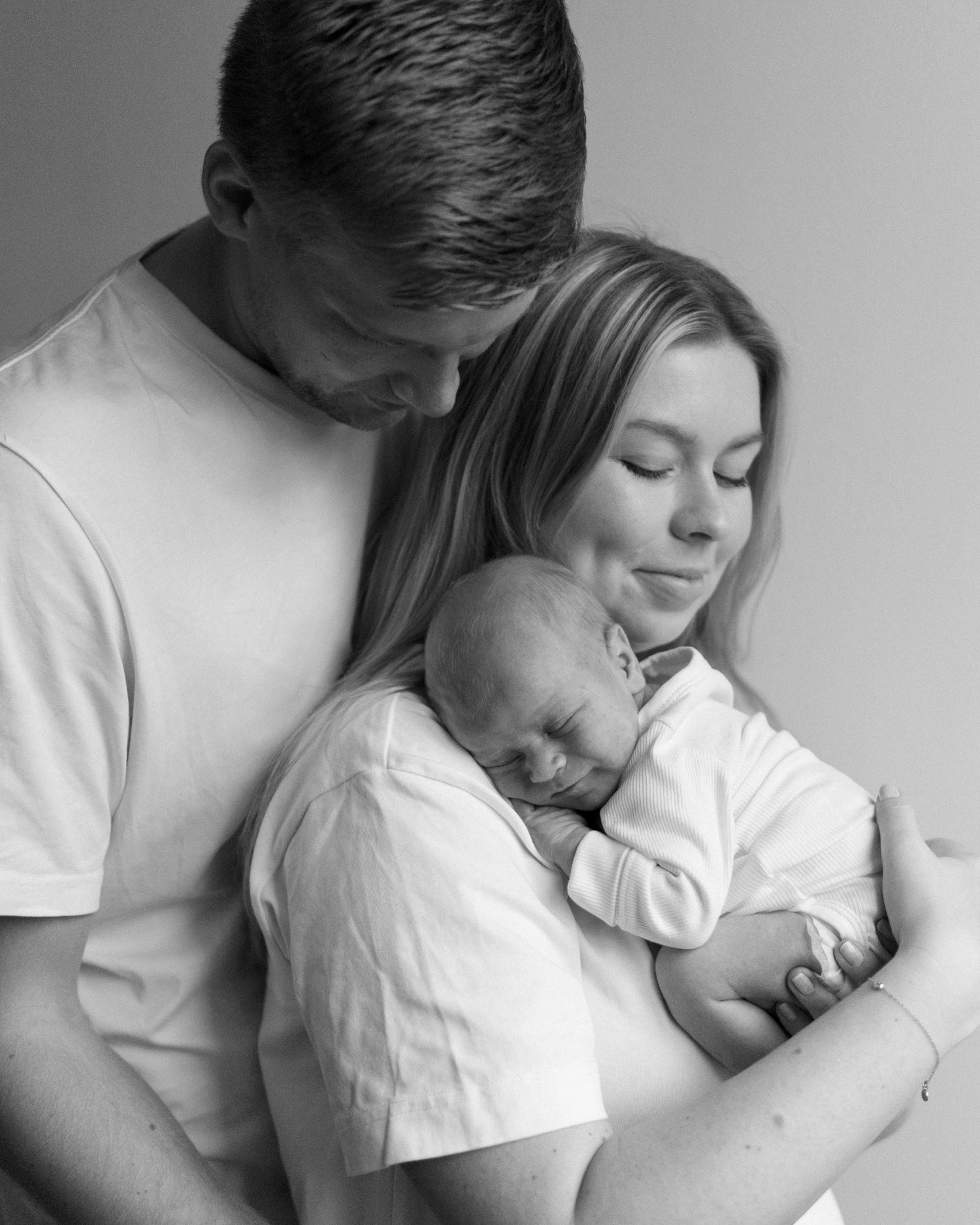 Intimate black and white portraits showing tender moments between two people.