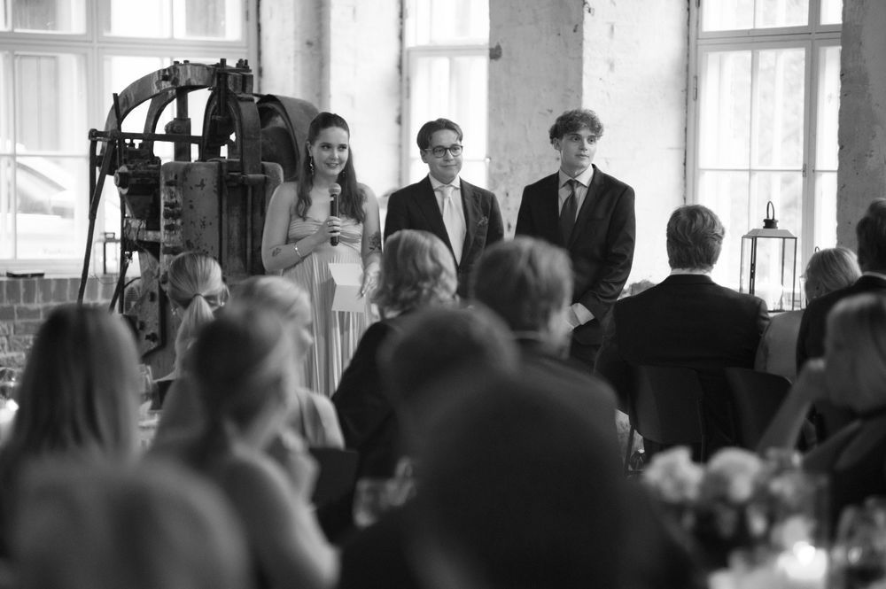 Large gathering of guests seated in rows during an indoor event.