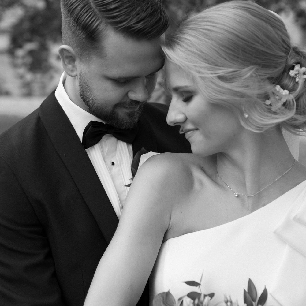 An intimate black and white wedding portrait showing tender moments.
