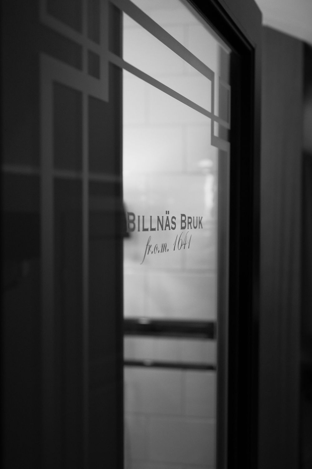 Window frames with text signage visible through frosted glass panels.