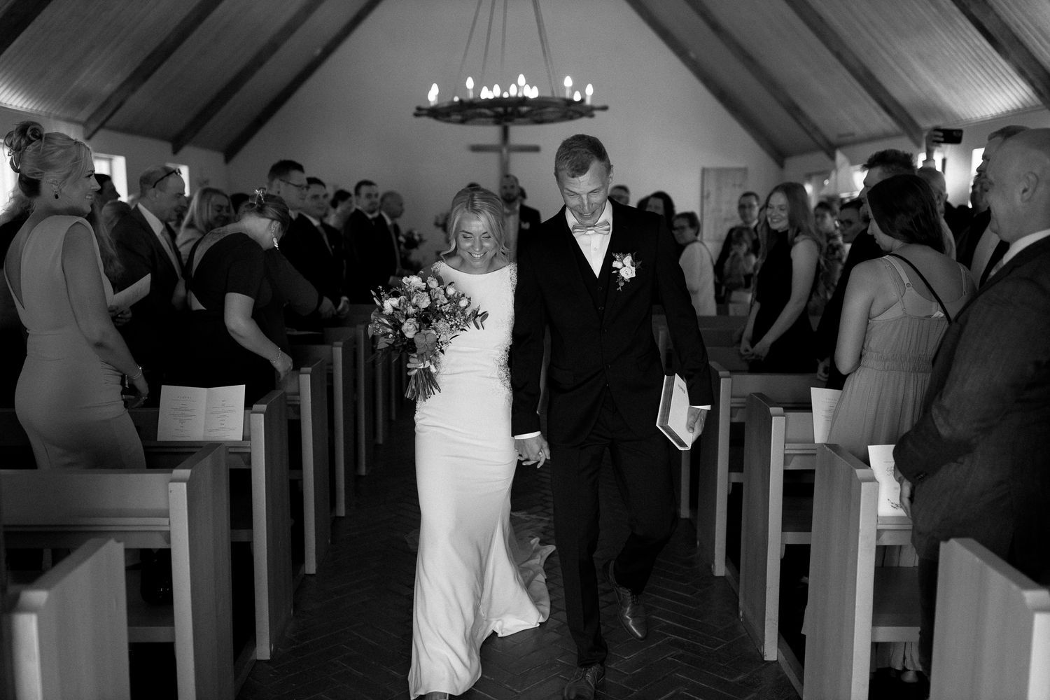 Dramatic black and white capture of a wedding ceremony in progress.