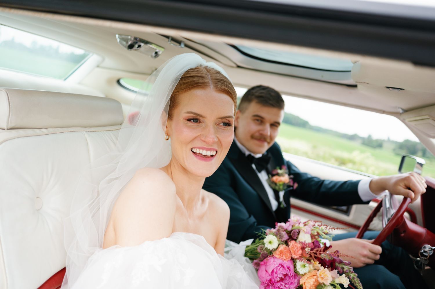 Interior view of a classic car showing elegant wedding day transportation details.
