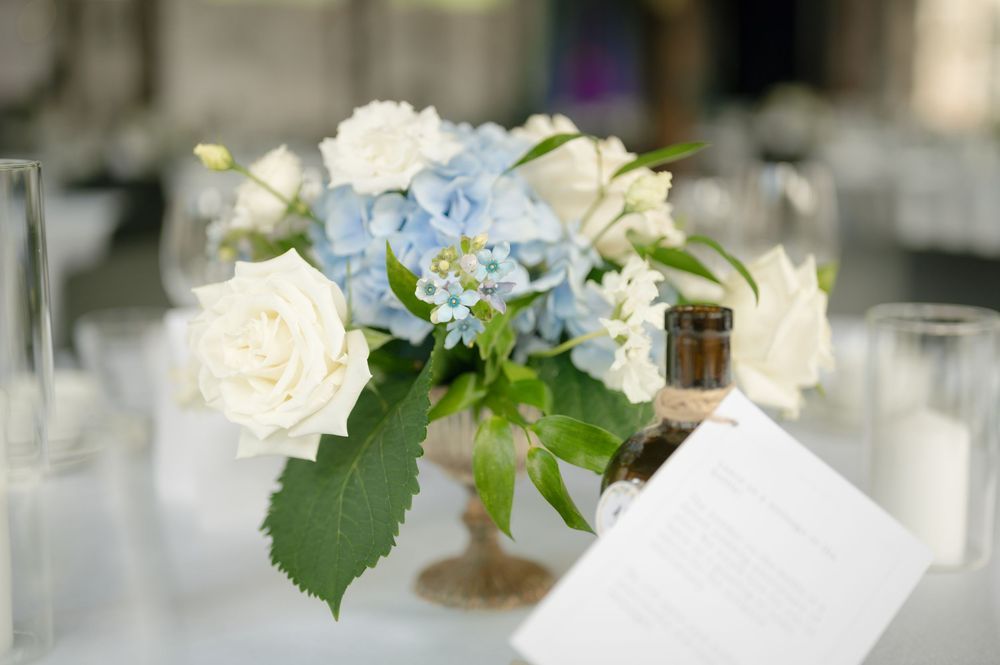 White and blue floral centerpiece arrangements for wedding reception.