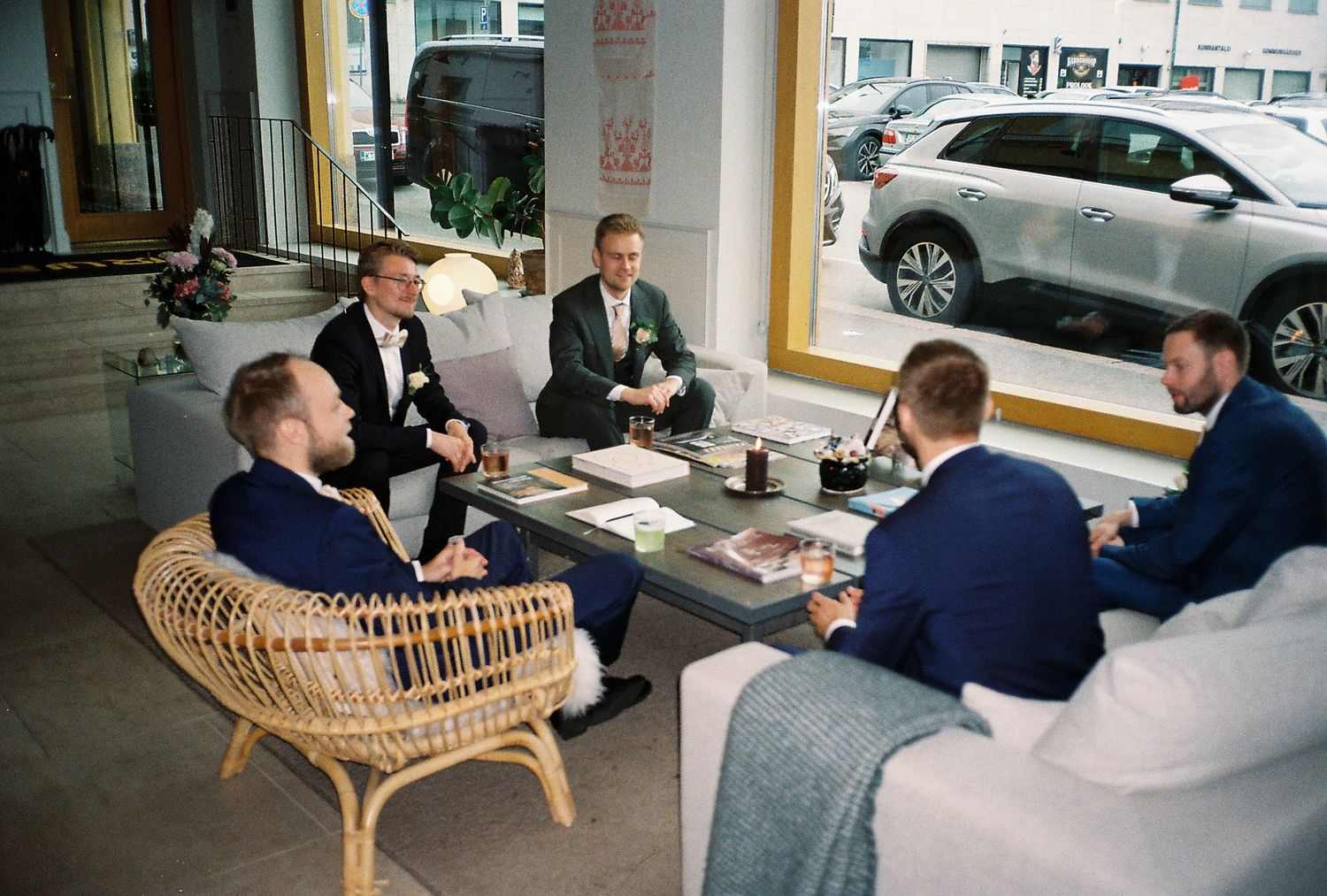 Casual meeting with people seated on rattan furniture in a modern office setting.