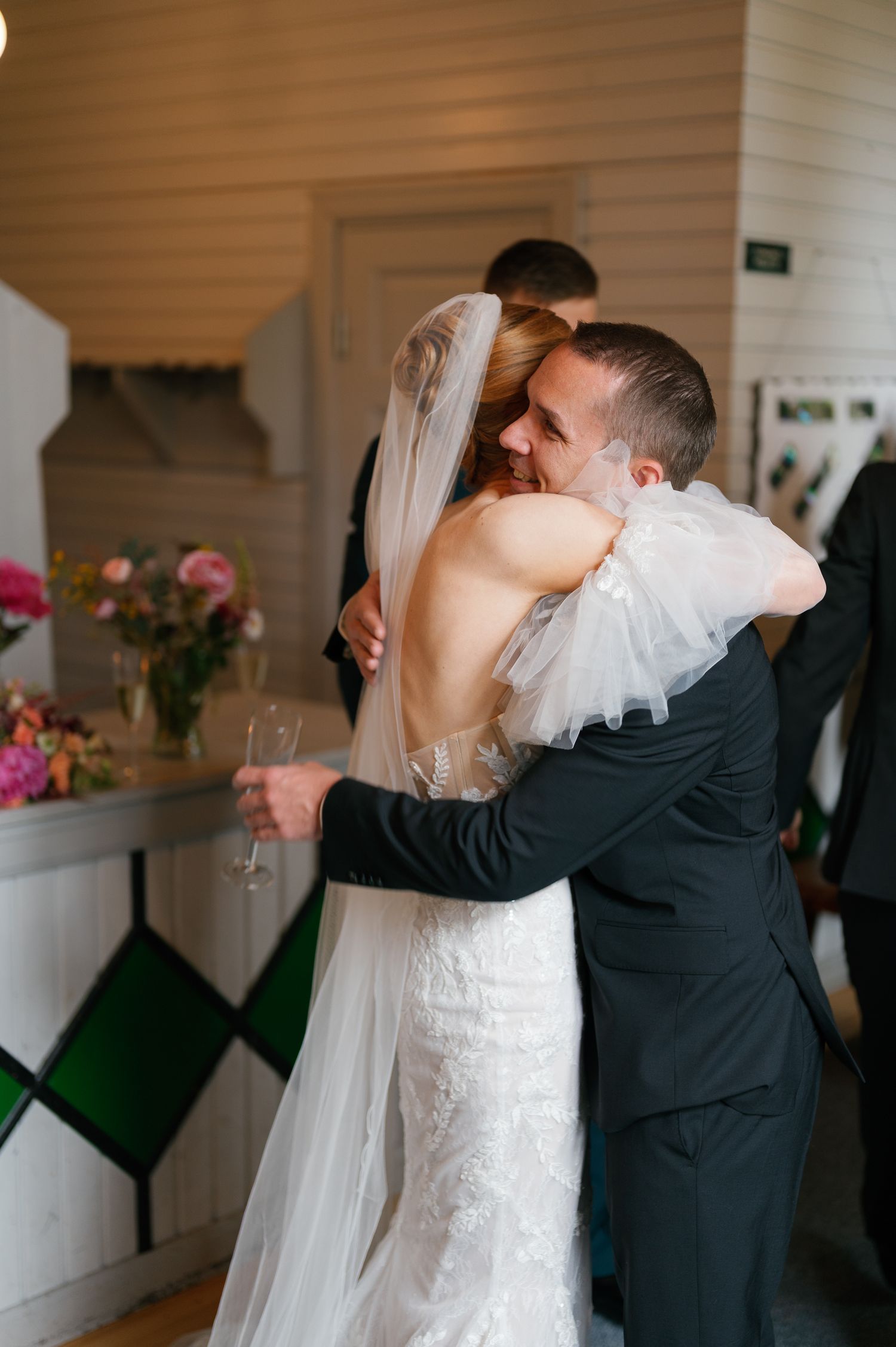 Wedding celebration moment showing a tender embrace in formal attire.