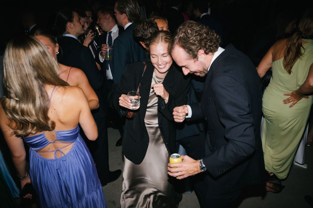 Guests mingling and dancing at an elegant evening party.