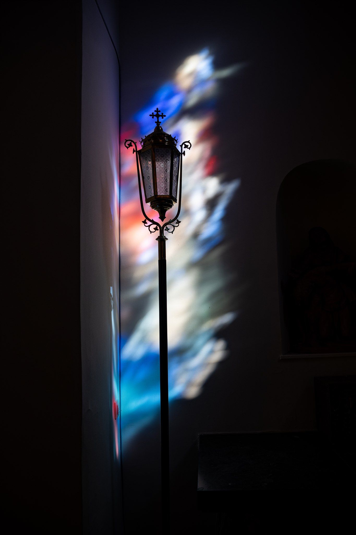 Artistieke doopsel fotografie in kerk van Afsnee met reflectie van brandglas