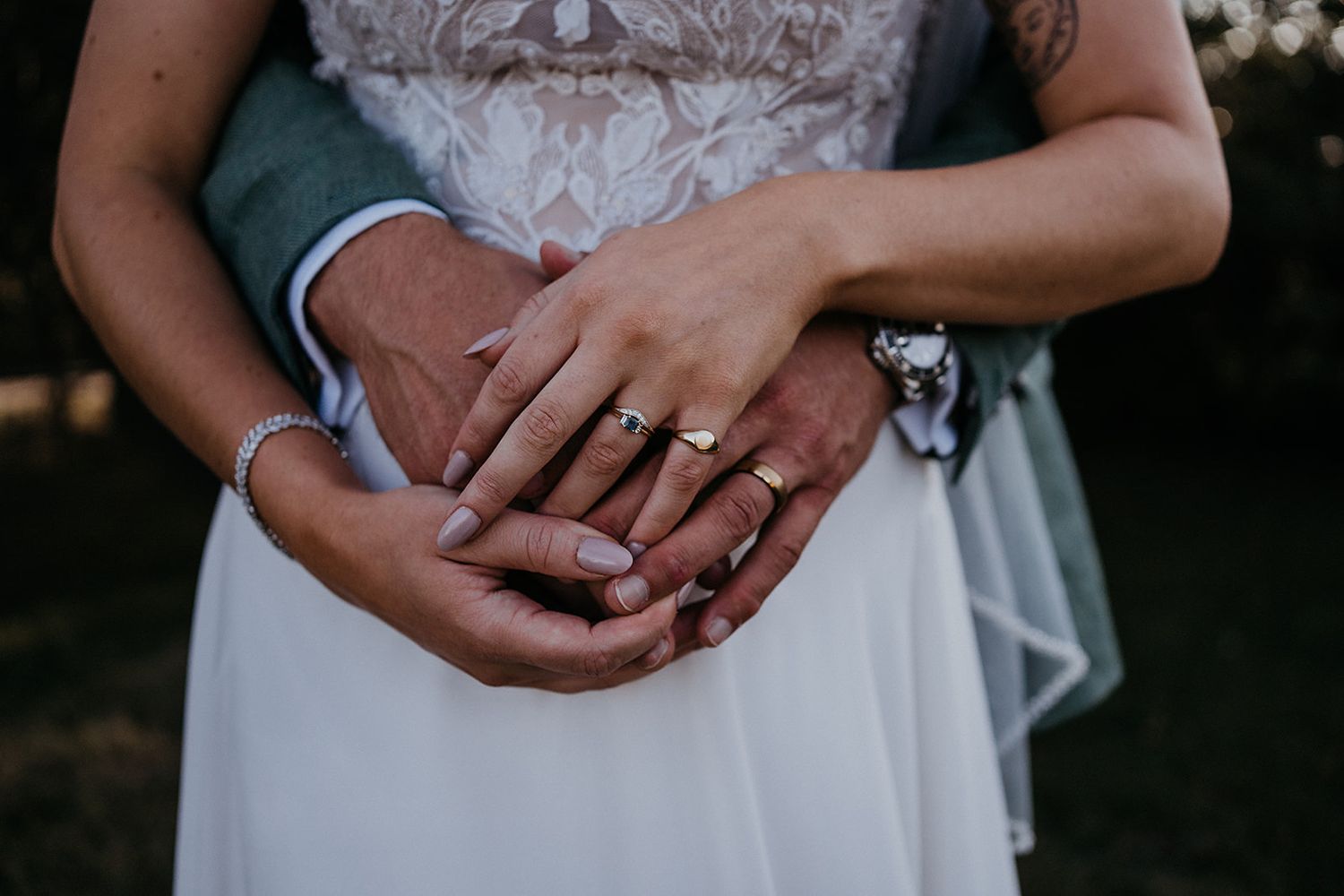 close up pf the bride and grooms hands with their rings