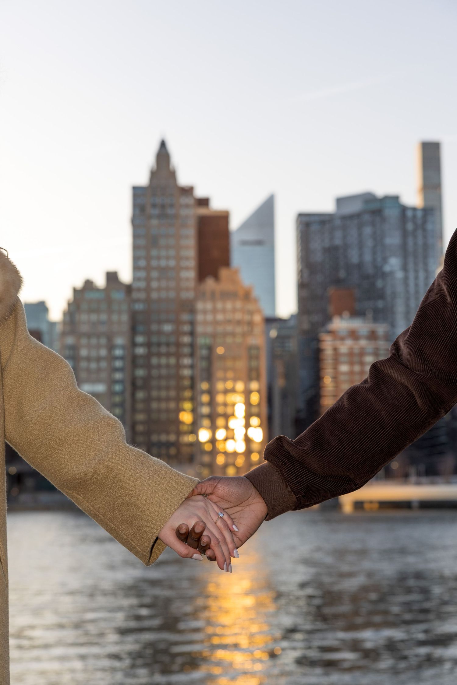 Couple during surprise proposal with NYC skyline