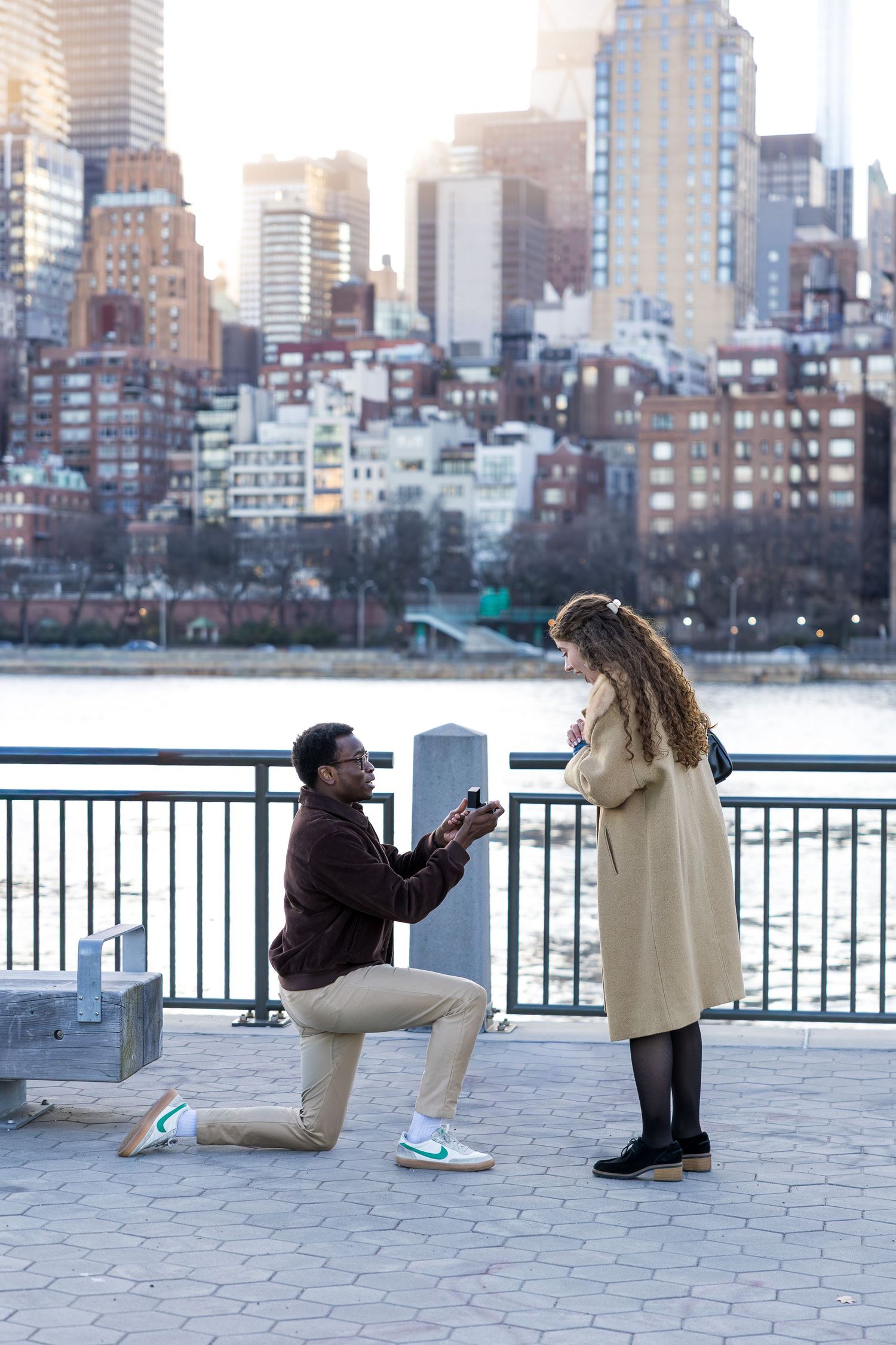 Couple during proposal with NYC skyline