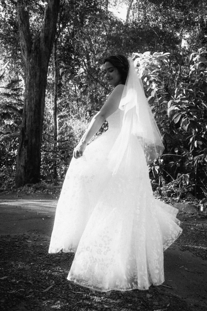Flowing white wedding dress twirling in an outdoor garden setting.