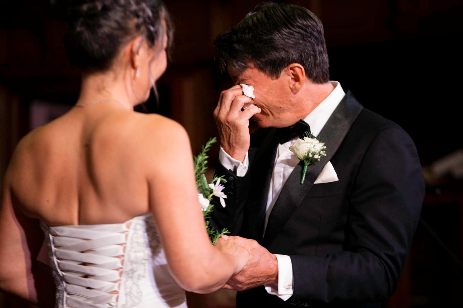 A romantic wedding couple shares a tender moment during their first dance on the dance floor at their reception.