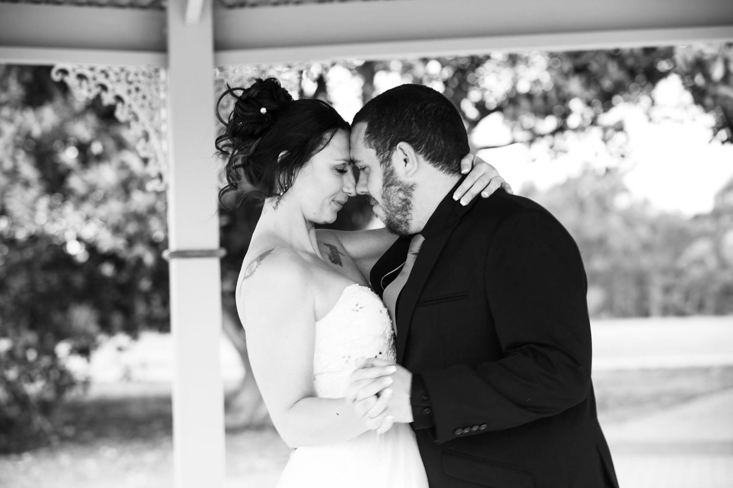 A black and white photo collage of romantic wedding moments showing couples embracing and dancing together.