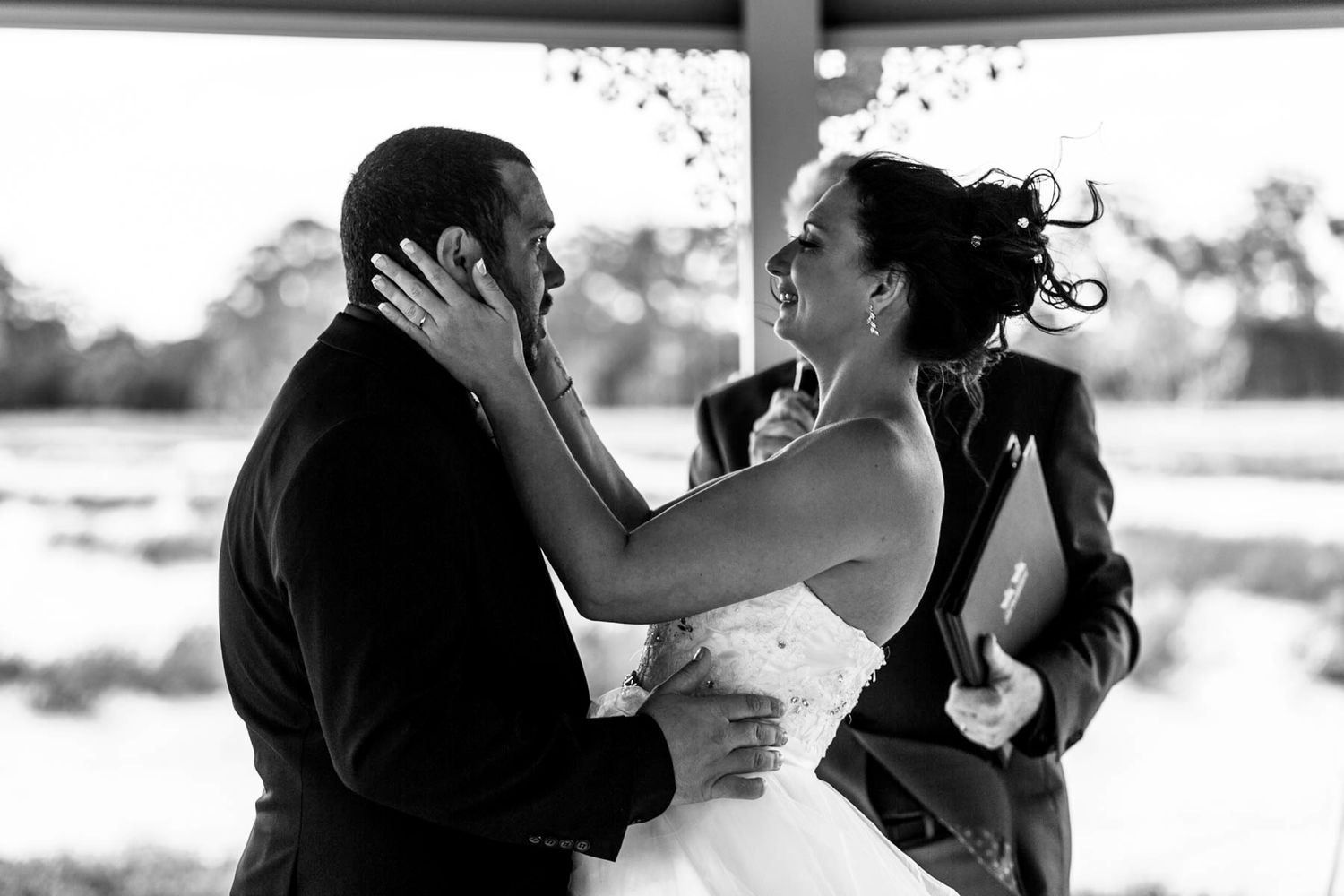 A series of black and white wedding photos showing couples in romantic moments.