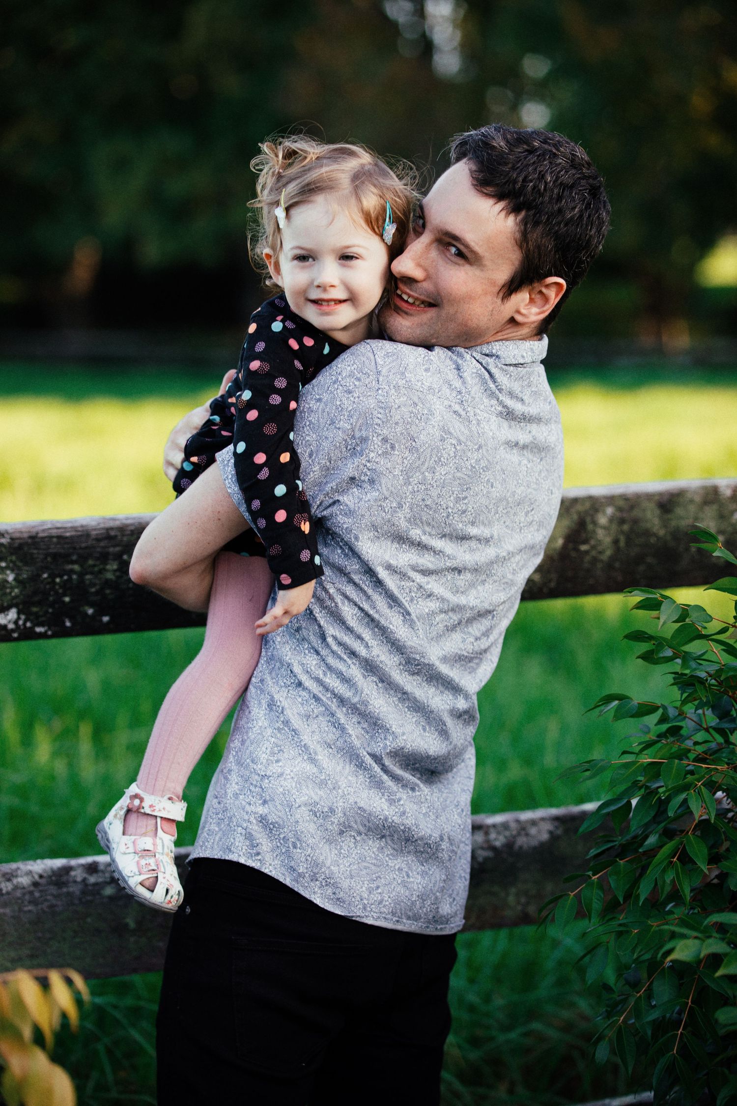 Playful moments captured in a lush green garden setting on a sunny day.
