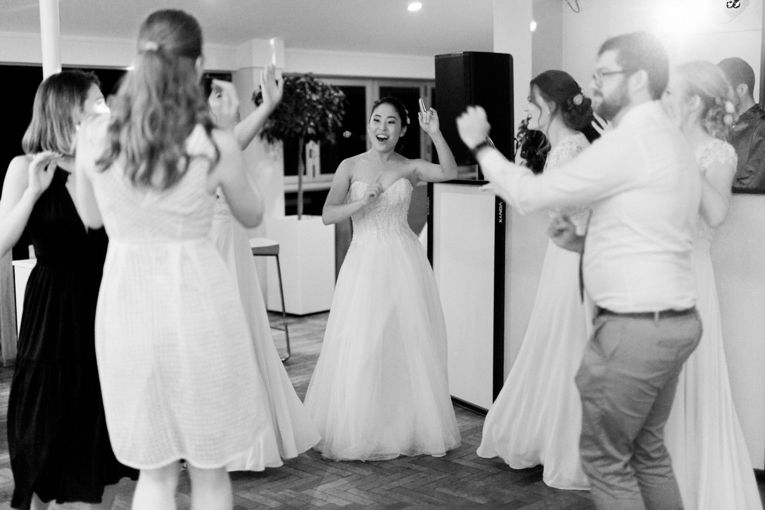 Wedding guests form a circle during a traditional dance celebration.