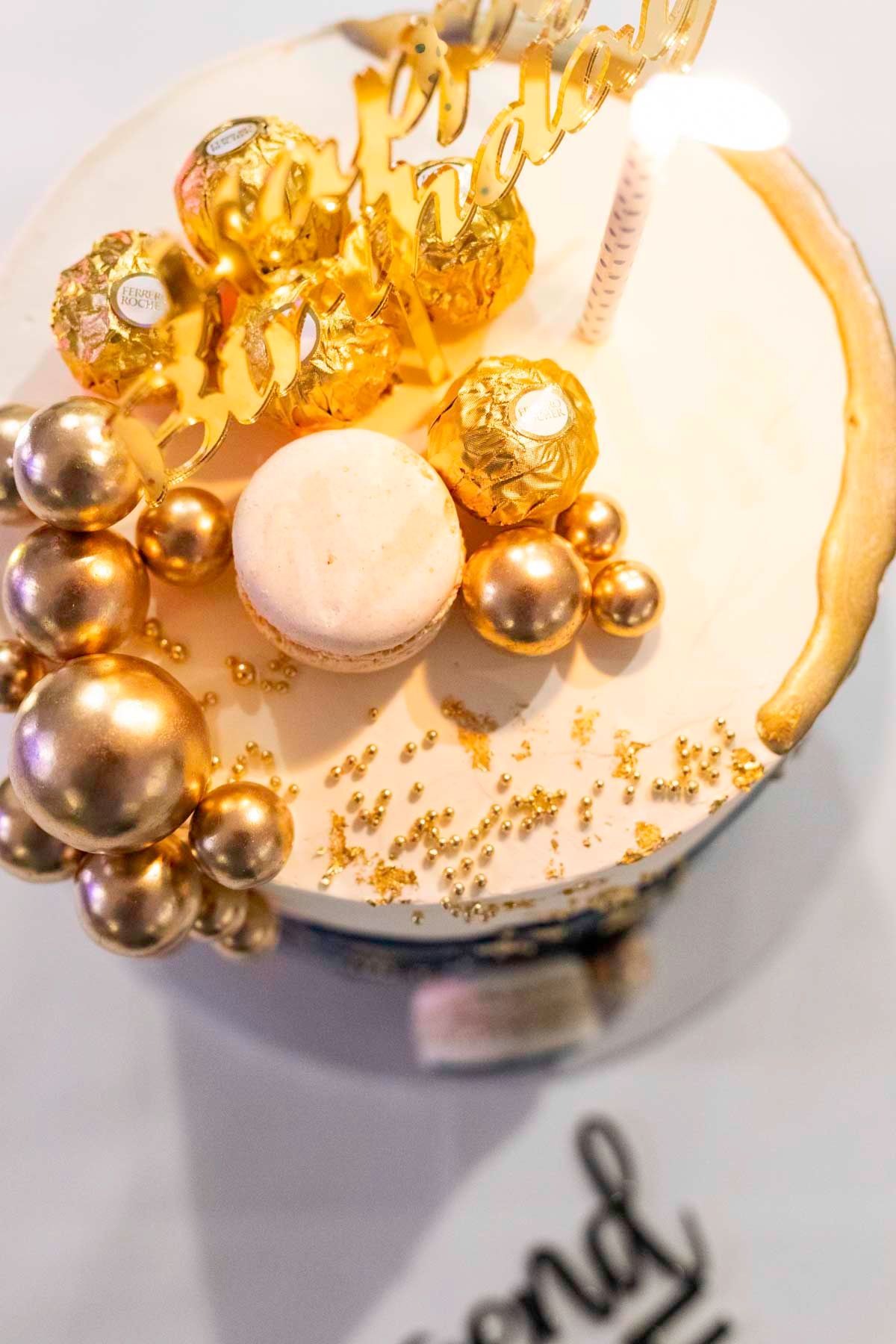 Elegant gold jewelry with pearls and metallic accents arranged on a white surface in a creative composition.