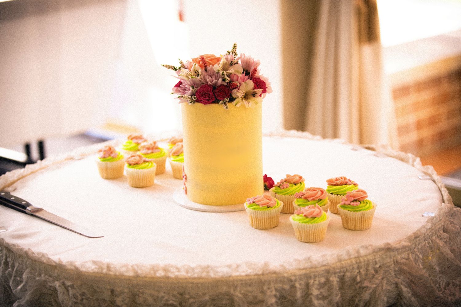 Wedding reception table decorated with colorful drinks and appetizers.