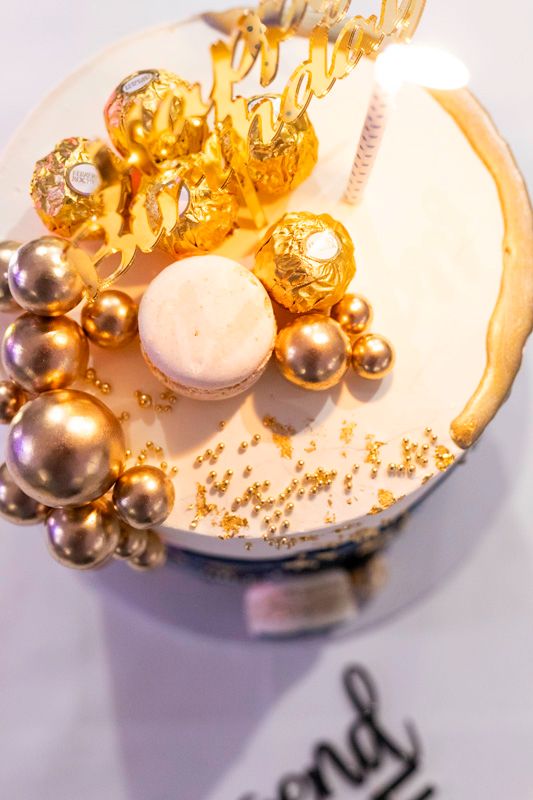 Gold and pearl decorative elements arranged on a white surface.