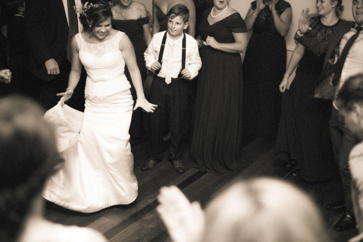 Wedding guests enjoying themselves on a dimly lit dance floor.