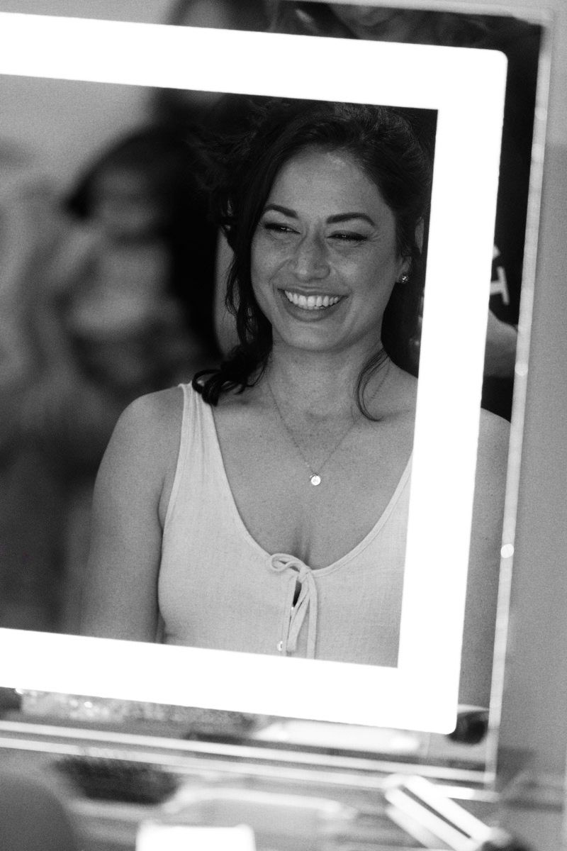 Black and white portrait photographs showing joyful expressions in a series of candid shots.