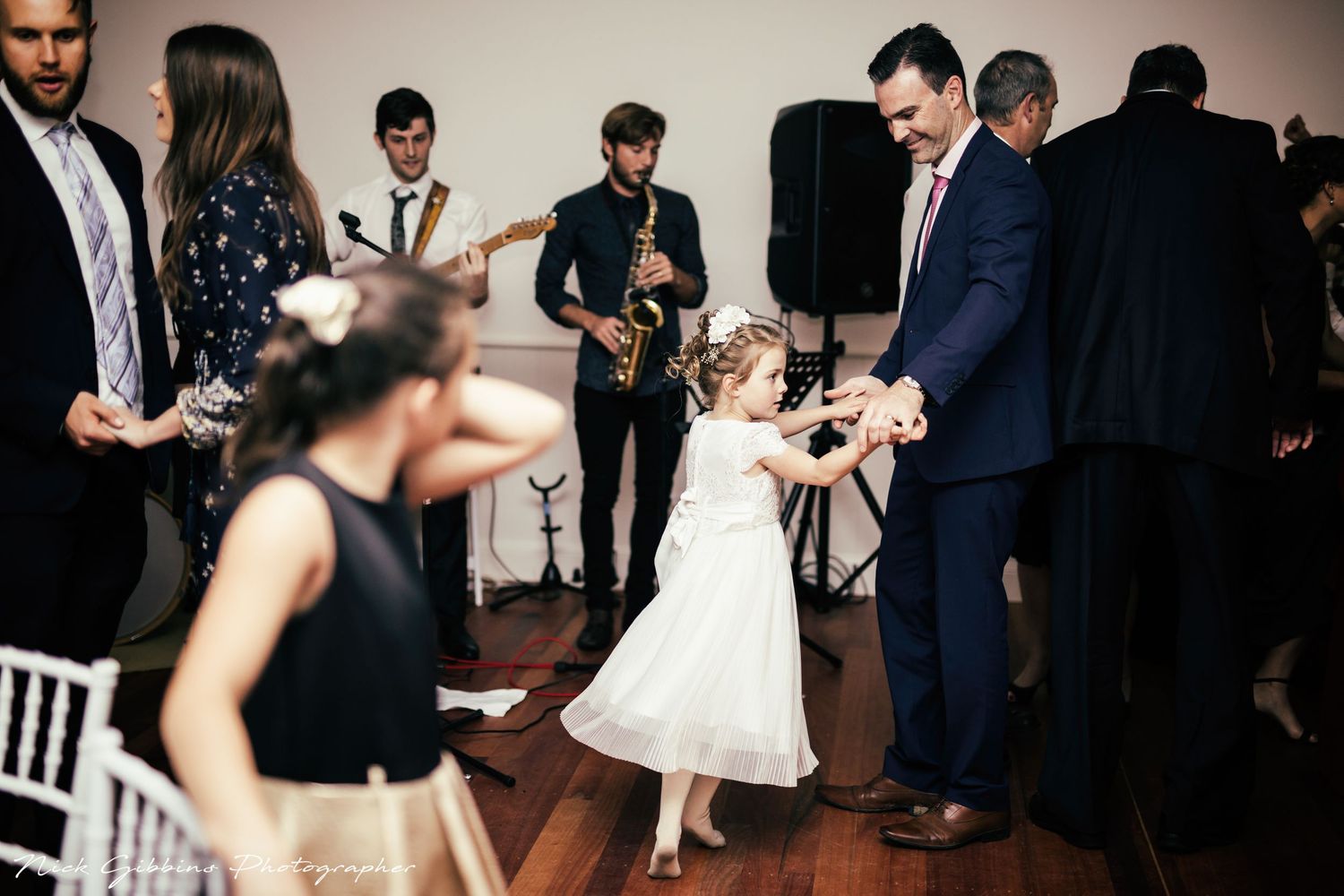 Dance floor filled with guests celebrating at an evening reception party.